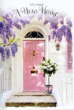 At this Cockfosters doorway, flowers and architecture come together to tell a gentle story of fresh starts and warm welcomes. The front door, painted in a soft blush pink that feels both modern and nostalgic, stands calmly beneath an arch of wisteria, its panels reflecting the light in subtle, satin-like highlights. The shutter nearby shares the same hue, creating a harmonious frame that immediately draws the eye. Above and around, the wisteria drapes in long, graceful garlands, each strand dotted with tiny blossoms in shades of lavender, lilac, and soft violet. These clusters tumble down in irregular yet beautifully balanced lines, casting filigree shadows on the whitewashed wall, just as branches might on a sunny day near Chalk Lane. The wall itself is gently textured, its pale surface amplifying the sense of brightness and airy space. At the base of the doorway, resting just where guests would step up, stands a weathered grey tin bucket, sturdy yet understated. From it emerges an exuberant bouquet of creamy white and pale ivory roses, each bloom lush and full, their petals cupping and unfurling like waves of silk. Fine sprays of fresh greenery are threaded throughout, adding whispers of soft green that keep the arrangement feeling light and garden-fresh. A satin ribbon in muted rose-pink wraps around the bucket, tied into a neat, lyrical bow whose long ends lie softly against the stone. The overall feeling is one of poised anticipation and quiet joy-the sort of floral scene that might greet someone returning from a long day, or standing at their doorway for the first time with a new set of keys. It's a visual blessing of comfort, celebration, and the promise that this house will soon become a true home.